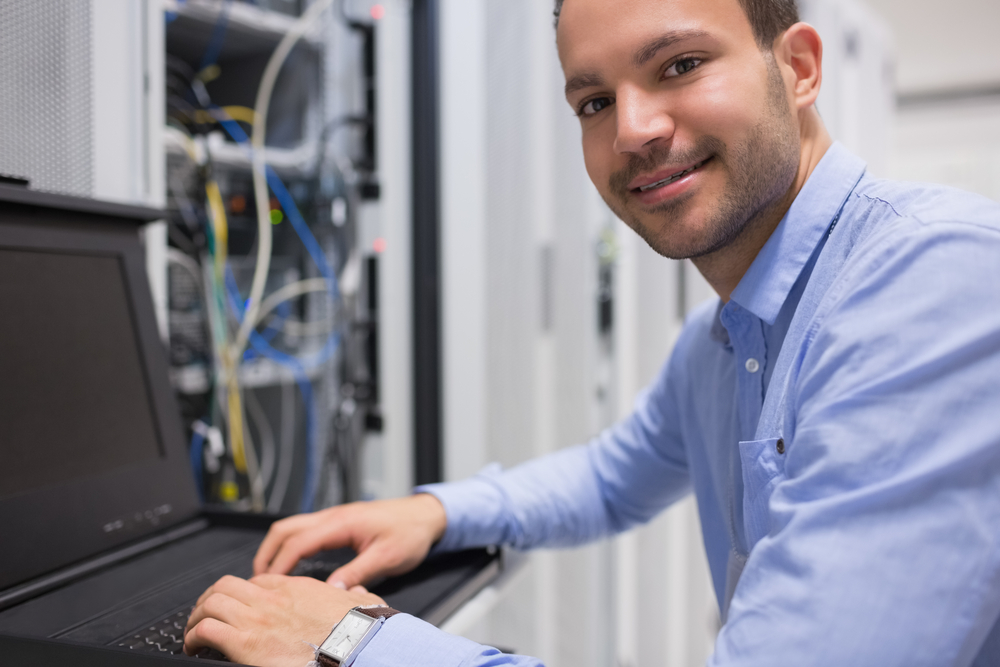 Man searching through servers in data center